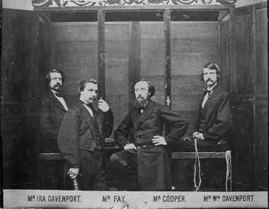 This Davenport brothers and William Fay in front of the "spirit cabinet", 1870